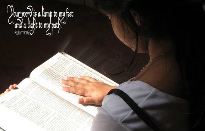 Young girl reading Bible