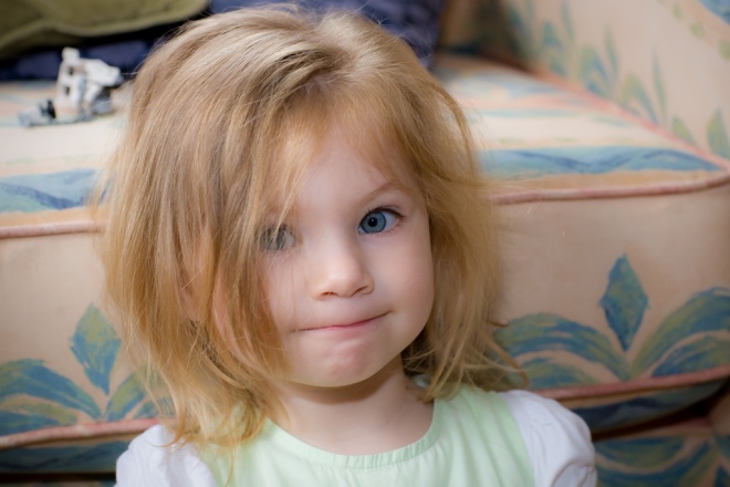 awful hair day for adorable strawberry blonde blue-eyed toddler, pastels and print in background
